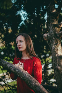 Portrait of young woman on tree