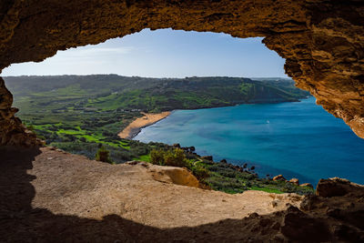 Scenic view of sea and mountains against sky