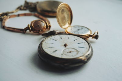 Close-up of antique watches on white table