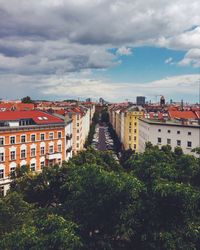 Buildings against cloudy sky