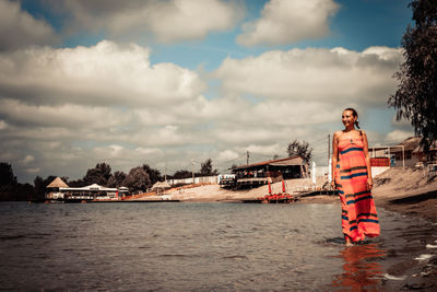 Woman standing on boat against sky