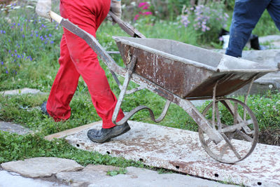 Low section of men working on plants