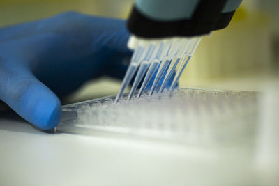 Cropped hand of scientist working on table