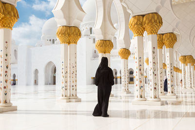 Rear view of woman walking in mosque