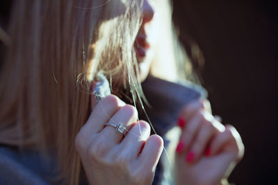 Midsection of woman holding collar in sunny day