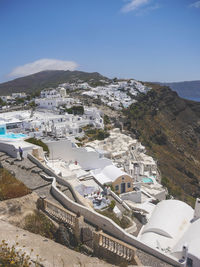 High angle view of town by sea against clear sky