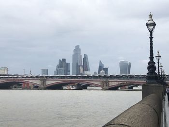 Bridge over river with buildings in background