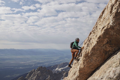 Male rock climber ascends the exum ridge route on the grand teton.