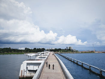 Bridge over sea against sky in city