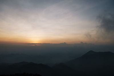 Scenic view of silhouette mountains against sky during sunset