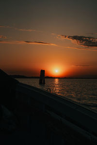 Scenic view of sea against orange sky