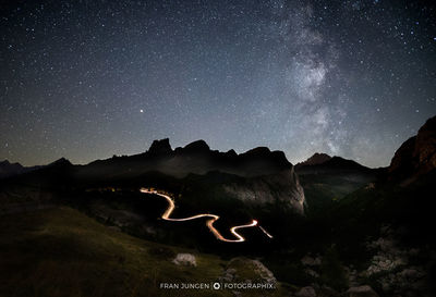 Scenic view of illuminated mountain against sky at night