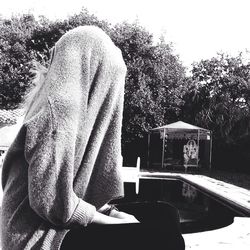 Woman standing on tree trunk