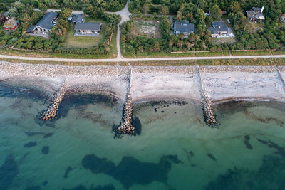 High angle view of swimming pool by sea against buildings