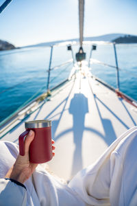 Low section of woman holding boat