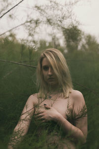 Portrait of beautiful woman on field