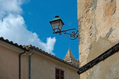 Low angle view of street light against building