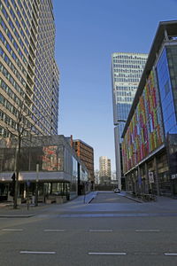 Street amidst buildings against sky in city