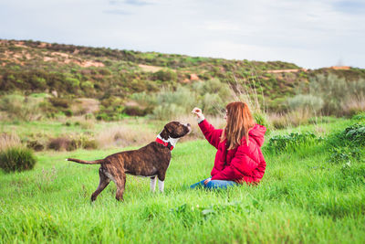 Woman with dog on field