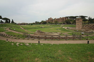 View of old ruin on field against sky