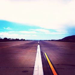 Road by landscape against sky