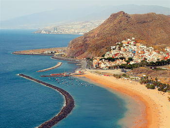 High angle view of sea and buildings against sky