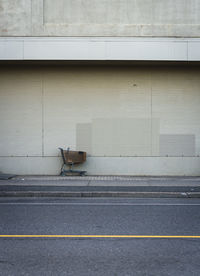 Sculpture of woman with striped stockings on brick wall.