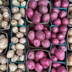 High angle view of potatoes in containers at market for sale