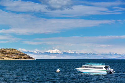 Boat moored in sea against sky