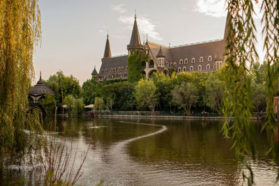 Panoramic view of lake and buildings against sky