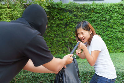 Young woman using mobile phone in park