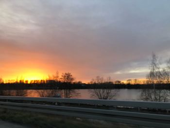 Scenic view of river against sky during sunset