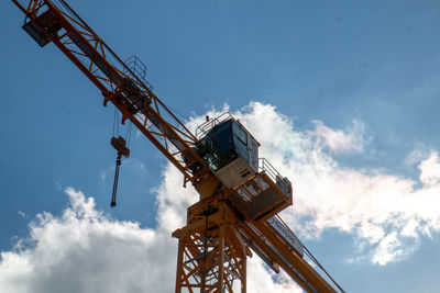 Low angle view of crane against sky