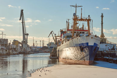 Moored cargo ships and harbor cranes in port. seaport, cargo container yard, container shipyard