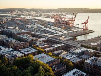 High angle view of cityscape by sea against sky