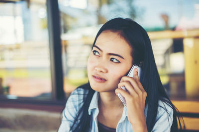 Portrait of young woman using mobile phone