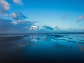 Scenic view of sea against blue sky