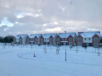 Houses in winter against sky