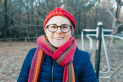 Portrait of woman wearing knit hat at park