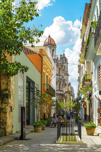 Street amidst buildings in city against sky