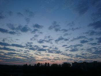 Silhouette trees against sky during sunset