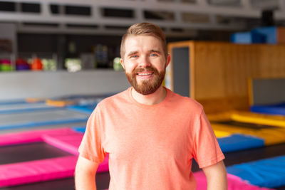 Portrait of smiling man standing at gym