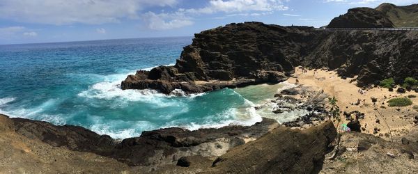 Scenic view of rocks on beach against sky