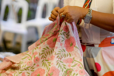 Midsection of woman holding textile