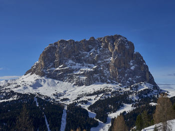 Scenic view of snowcapped mountain peak against clear blue sky