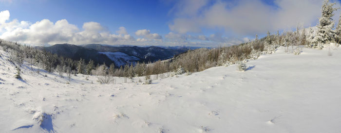 Scenic view of snow covered mountains against sky