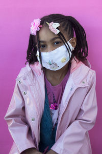 Portrait of beautiful woman against pink background