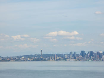 Scenic view of sea and buildings against sky