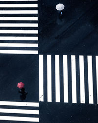 High angle view of man walking on road