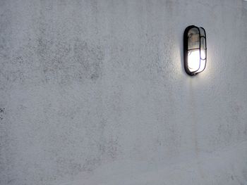 Low angle view of illuminated light on wall